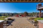 Sweeping Custom Patio with Adirondack Chairs and Firepit Area
